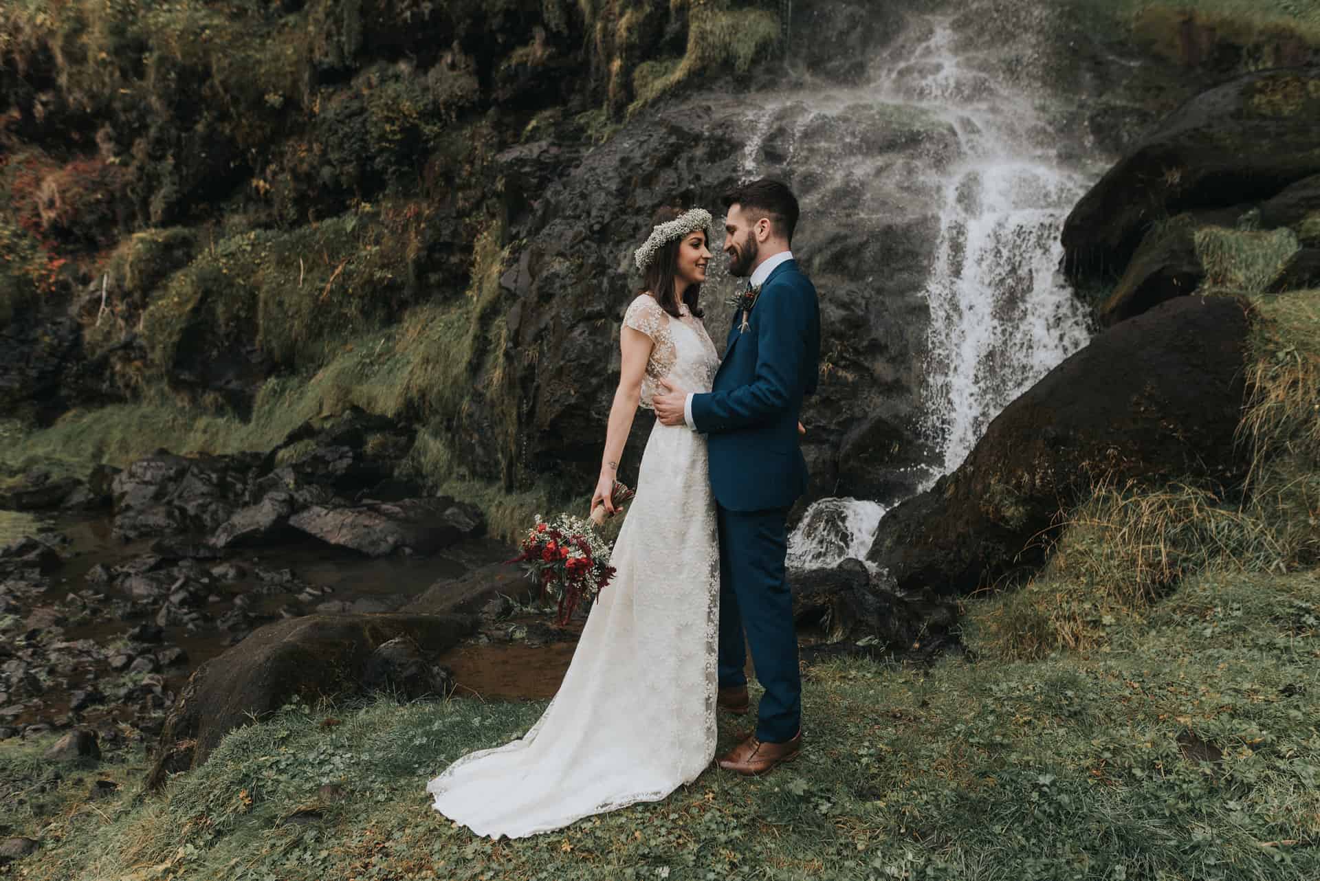 Couple kissing near waterfall in iceland